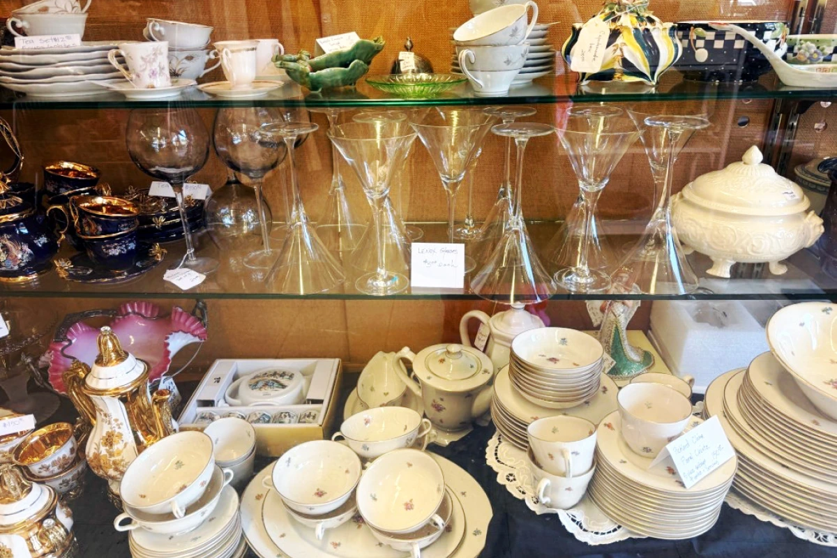 tea cups and wine glasses displayed on a glass cupboard